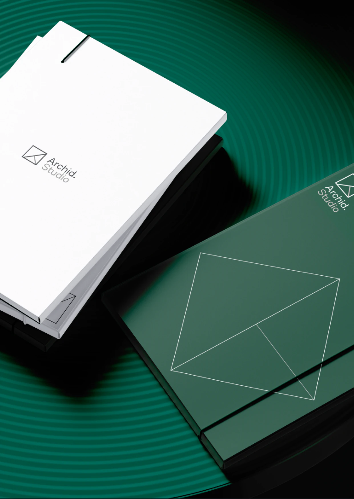 White and green Archid notebooks on a green surface