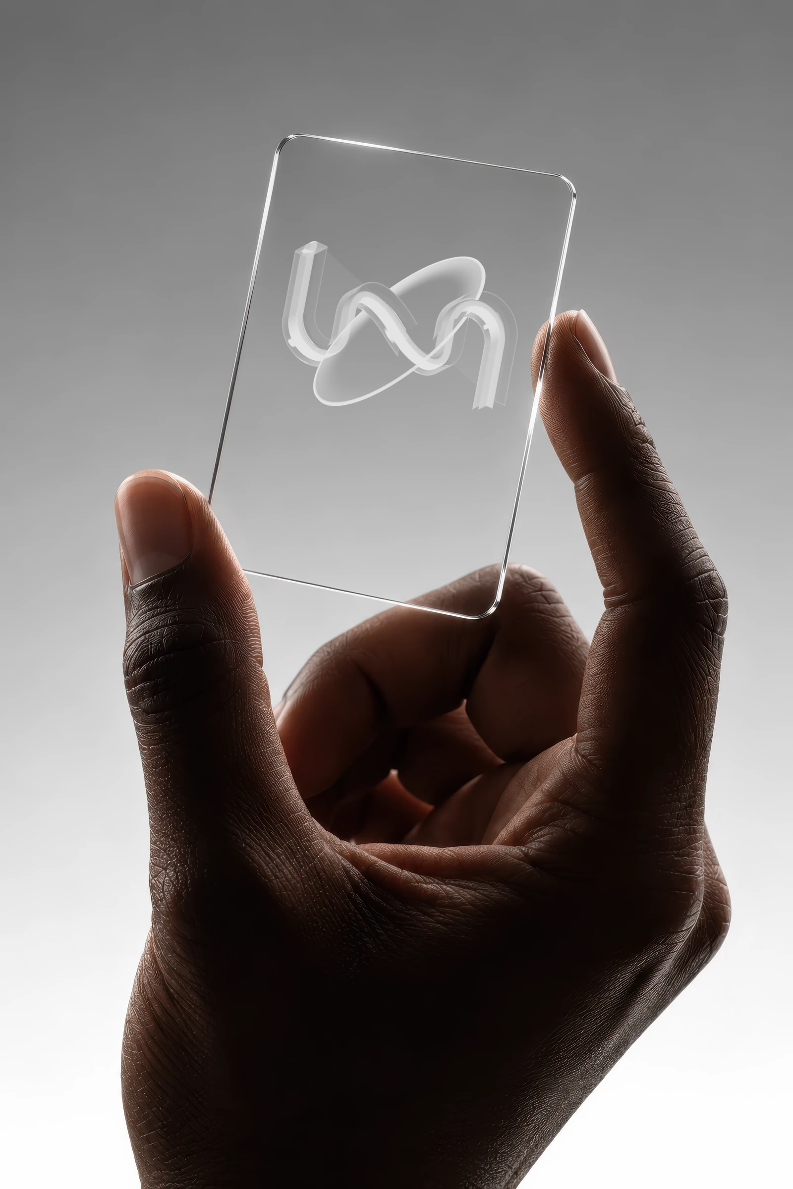 A hand holding a clear glass card with the Transactly mark printed in white