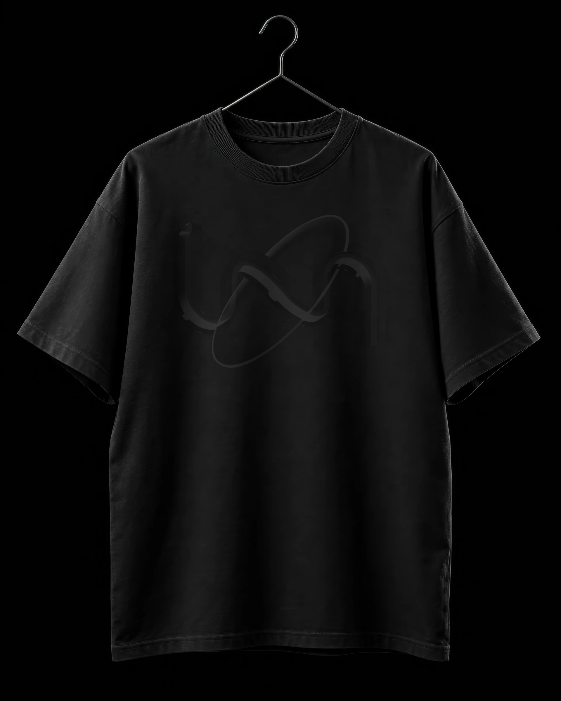 A black t-shirt on a hanger with the Transactly mark printed in glossy black on black