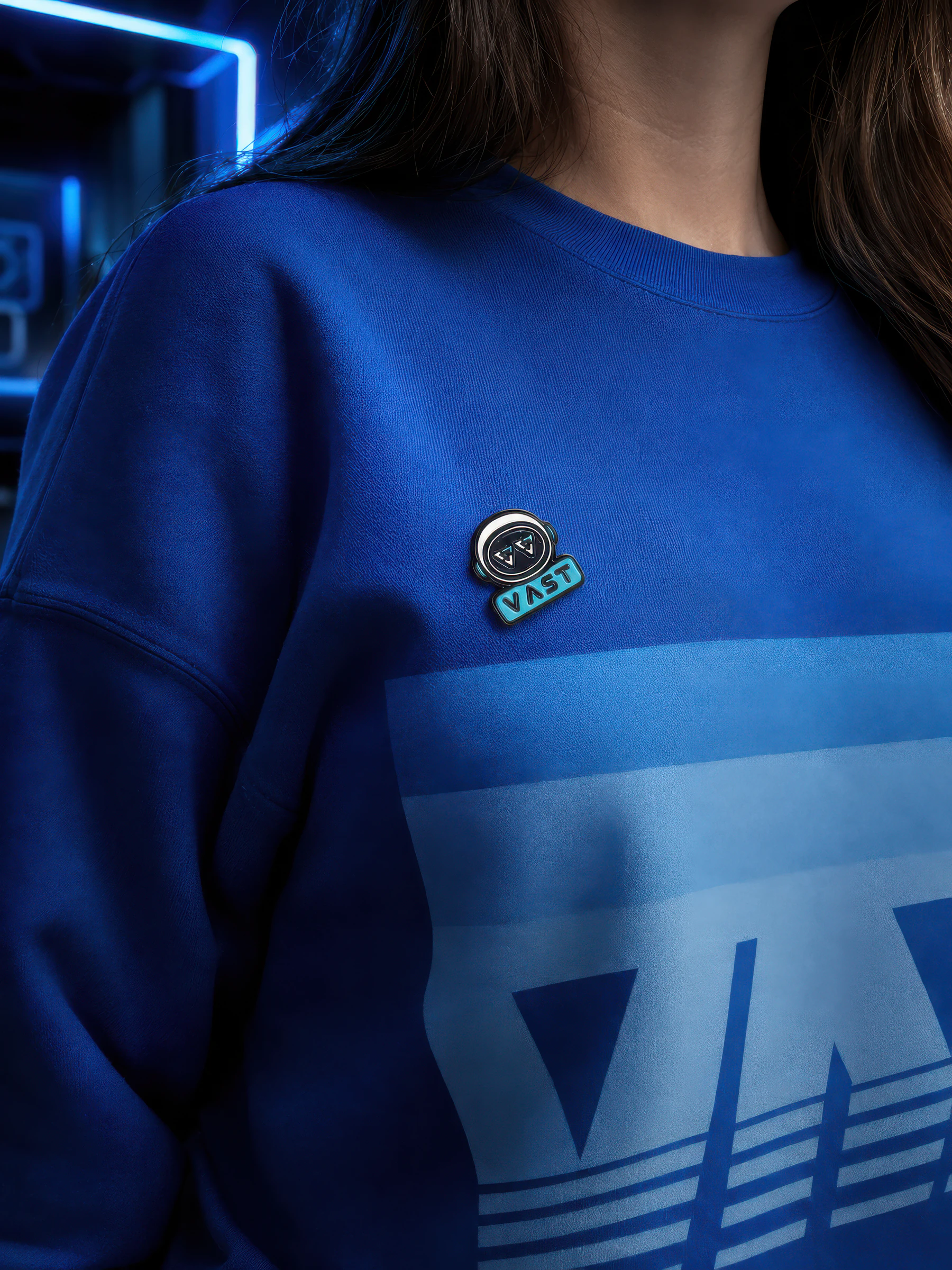 VASTronaut enamel pin worn on a sweatshirt